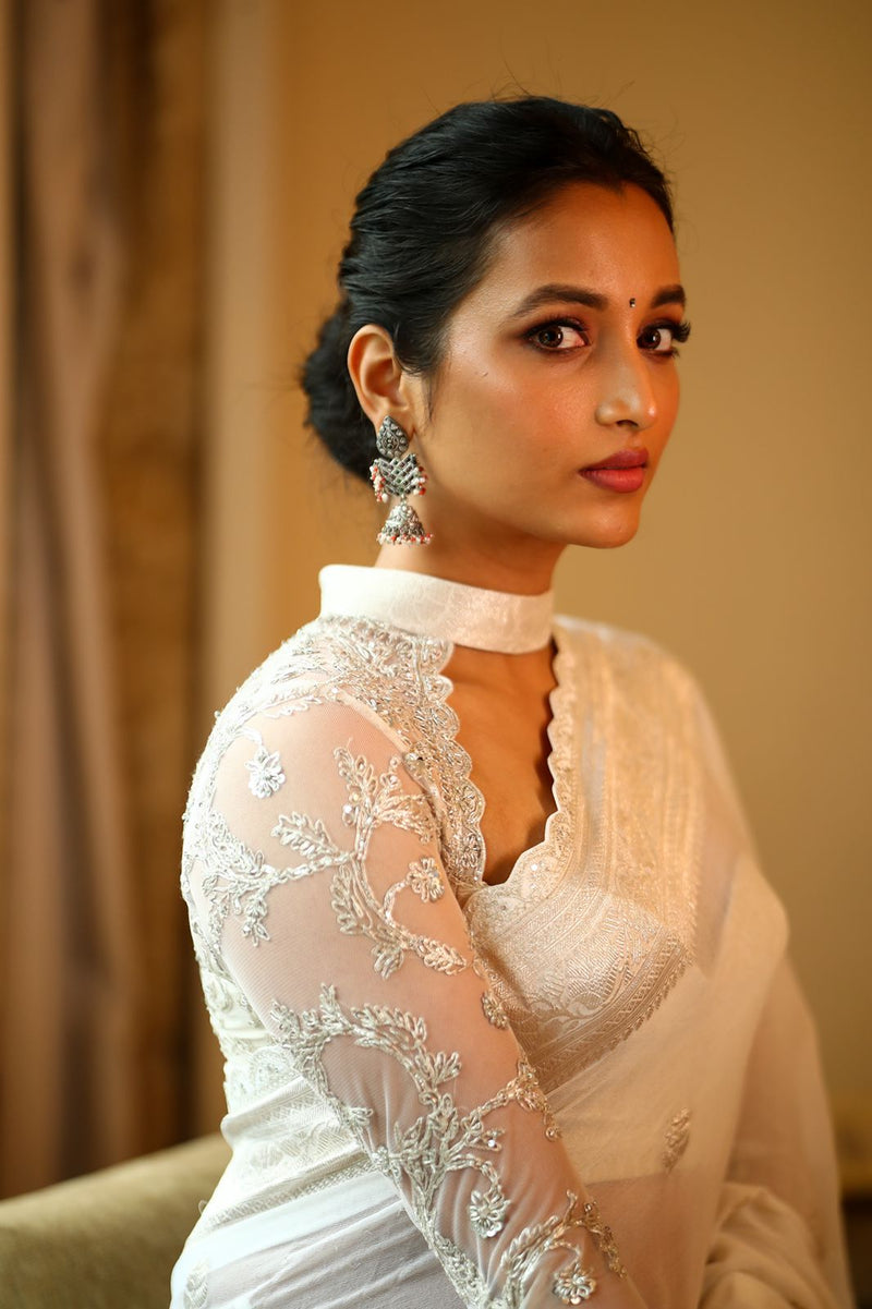 White banaras saree paired with embroidered blouse