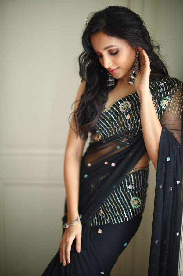 Black embroidered saree with sleeveless blouse
